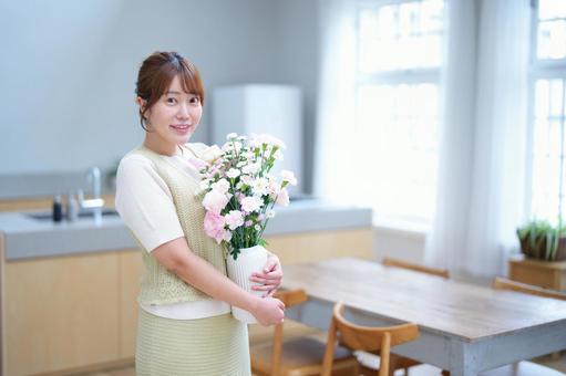 花びんを抱えて持つ女性 女性,花,花瓶の写真素材