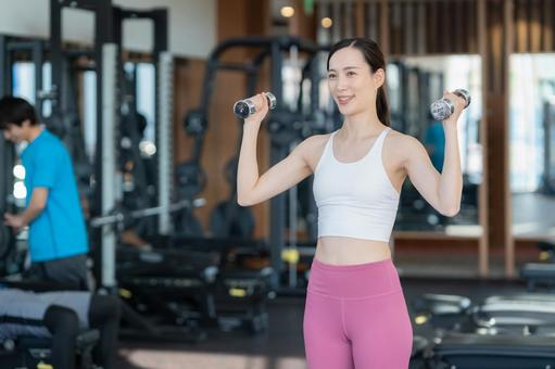 スポーツジムでトレーニングをする若い男女 スポーツジム,フィットネス,ダイエットの写真素材