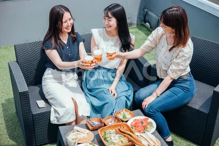 屋上でパーティーをする女性たち（ビール） ビアガーデン,パーティー,ホームパーティーの写真素材