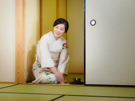 33:お茶をお出しする着物の女性 33:お茶をお出しする着物の女性 着物,おもてなし,お茶だしの写真素材