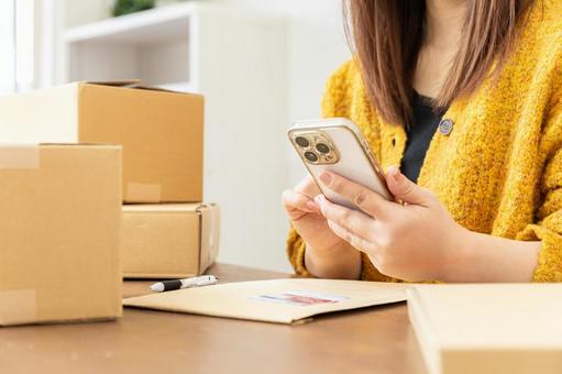 荷物の発送準備をする女性 配送,配達,段ボールの写真素材