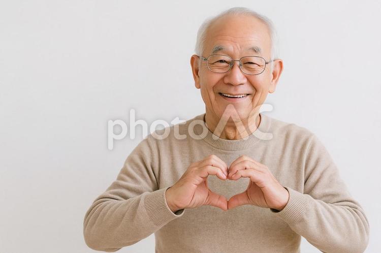 想いを伝える優しい仕草 シニア,ハートポーズ,笑顔の写真素材