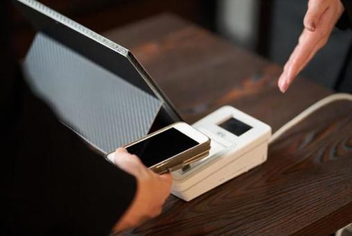 Hands of men making cashless payments Hands of men making cashless payments