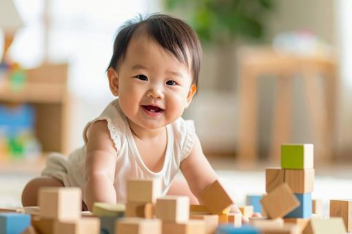 積み木で遊ぶ笑顔の赤ちゃん 積み木で遊ぶ笑顔の赤ちゃんの写真