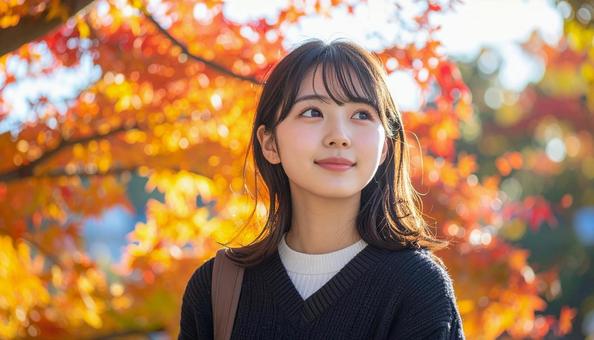 紅葉の鑑賞を楽しむ若い女性 紅葉の鑑賞を楽しむ若い女性の写真