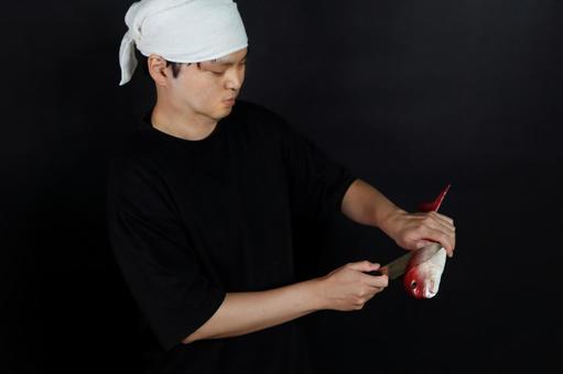 魚をさばく男性 魚をさばく男性の写真