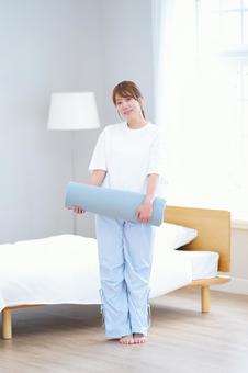 微笑み丸めたヨガマットを持つ女性 女性,ヨガマット,持つの写真素材