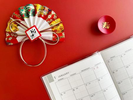 1月のスケジュール帳と新年の赤背景 スケジュール帳,1月,お正月の写真素材