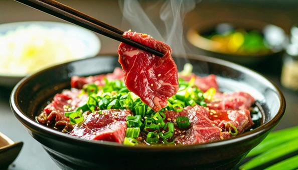 焼肉用の生肉を箸でつまむ 焼肉用の生肉を箸でつまむの写真