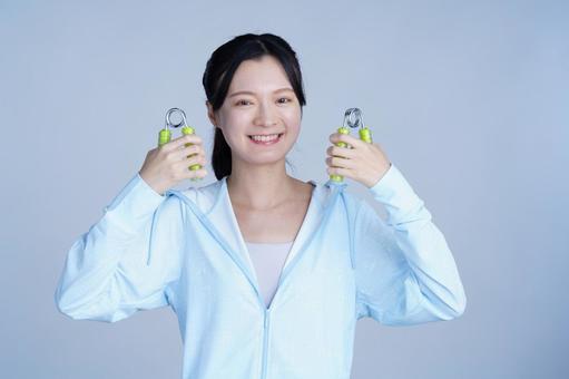 健康器具を持つ女性 女性,ハンドグリップ,握るの写真素材