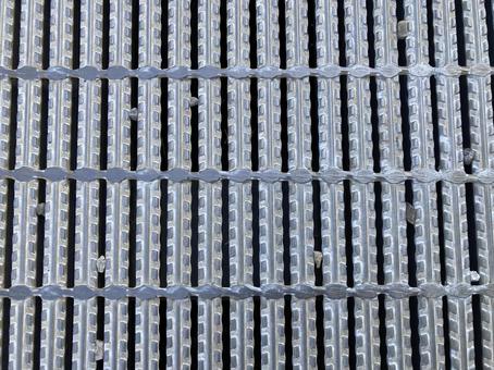 金属製のアスファルトの蓋背景素材 金属製,アスファルト,蓋の写真素材