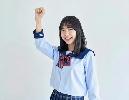 ガッツポーズをする女子生徒のイメージ ガッツポーズをする女子生徒のイメージの写真