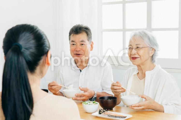 楽しい食事をする老夫婦と若い夫婦（笑顔） 家族,食事,里帰りの写真素材