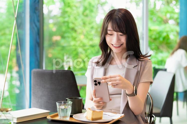 カフェでケーキの写真を撮影する女性 女性,カフェ,写真の写真素材