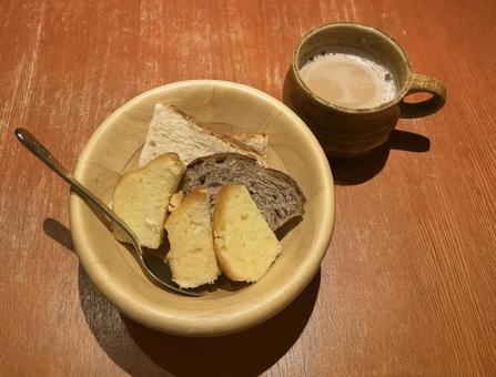 木の器に盛られたパンとコーヒー 木の器に盛られたパンとコーヒーの写真