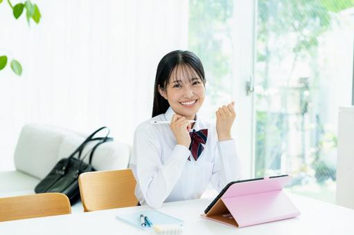 タブレットで勉強する女子高生 タブレットで勉強する女子高生の写真