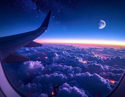 飛行機の窓から見える雲海と月の写真