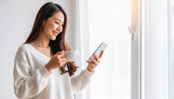 スマートフォンを見ながらリラックス スマートフォンを見ながらリラックスの写真