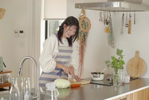キッチンで料理をする若い女性 キッチンで料理をする若い女性 料理,クッキング,キッチンの写真素材