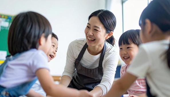 保育園で子供と遊ぶ笑顔の保育士の女性 保育園で子供と遊ぶ笑顔の保育士の女性の写真