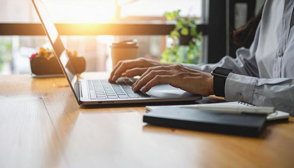 ノートパソコンで作業する手元の写真