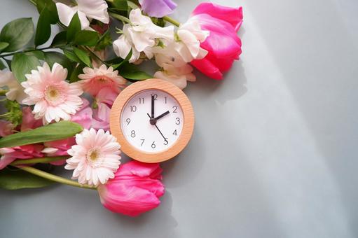 Spring time, desk clock and flower decoration background, JPG