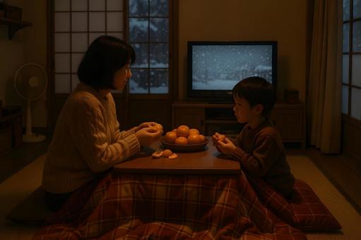 こたつでみかんを食べる親子 こたつでみかんを食べる親子の写真