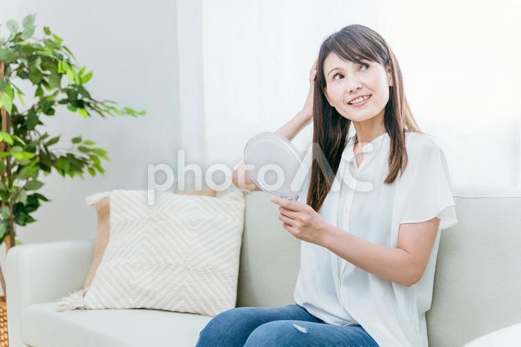 髪の毛が綺麗なミドル世代の女性 髪の毛,ヘアケア,ソファーの写真素材