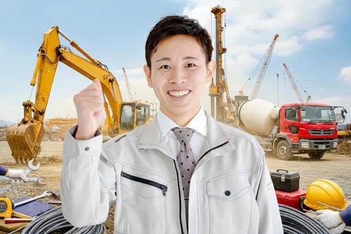 工事現場とガッツポーズの男性 工事現場とガッツポーズの男性 男性,作業員,作業服の写真素材