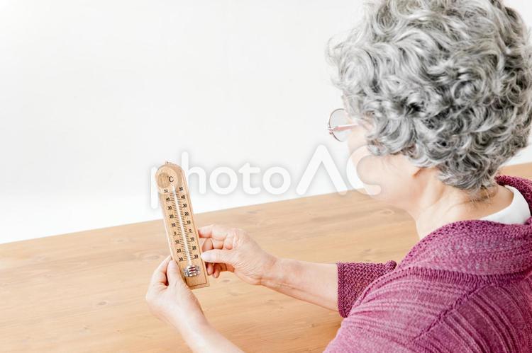 温度計を持つ高齢者の女性 温度,温度計,快適の写真素材
