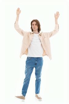 両手を上にあげカメラ目線の男性 両手を上にあげカメラ目線の男性の写真