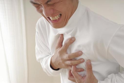 突然の発作に胸を押さえて苦しむ中年男性 心臓発作,狭心症,心不全の写真素材