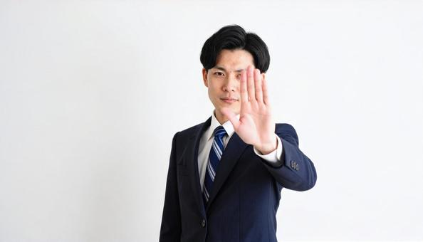 拒絶の意思表示をする日本人ビジネスマン 拒絶の意思表示をする日本人ビジネスマンの写真