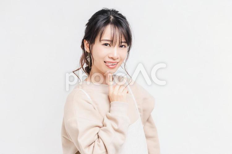 白い背景の前に立ってポーズをとる若い女性 女性,白背景,立つの写真素材