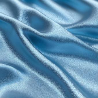 柔らかく波打つ青い布地の写真