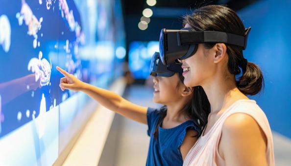 VRゴーグルで恐竜のホログラムを見る親子 VRゴーグルで恐竜のホログラムを見る親子の写真