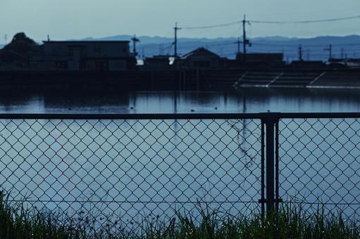A creepy reservoir and a no-trespassing wire fence, JPG