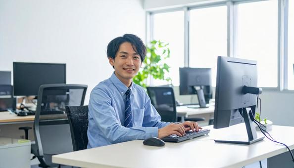 オフィスで働く日本人システムエンジニア オフィスで働く日本人システムエンジニアの写真