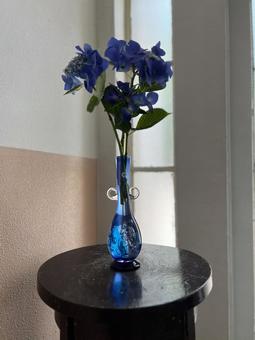 Deep purple hydrangea in a blue vase, JPG