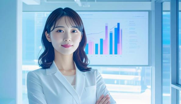 ディルプレイのチャートの前に立つ女性社員 ディルプレイのチャートの前に立つ女性社員の写真