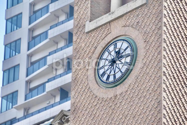 外壁に大きな時計のある建物 時計,オフィスビル,ビルの写真素材