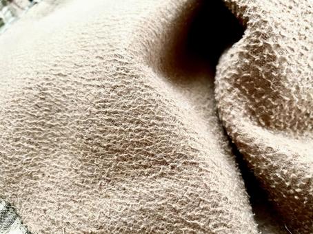 柔らかな薄茶色の布背景素材の写真