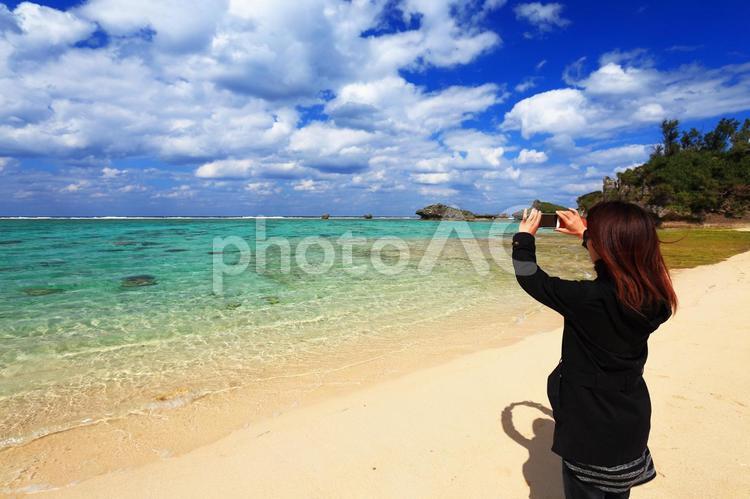 海を撮る女性(観光客) スマホ,スマートフォン,女性の写真素材