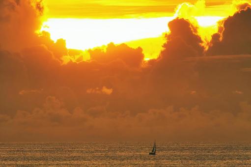A yacht floating on the horizon against a fiery sunset sky, JPG A yacht floating on the horizon against a fiery sunset sky, JPG