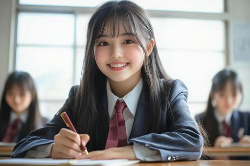 学校の教室で勉強する制服姿の女子高生 学校の教室で勉強する制服姿の女子高生の写真
