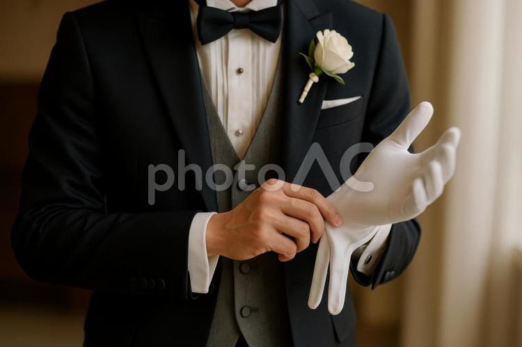 白い手袋をはめる新郎の手元 新郎,結婚式,ウェディングの写真素材
