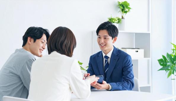 タブレットを使って説明する男性営業マン タブレットを使って説明する男性営業マンの写真