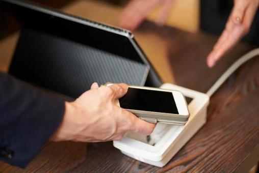 Hands of men making cashless payments Hands of men making cashless payments