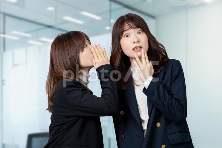 内緒の話を聞いて驚くビジネスウーマン 女性,ビジネス,ビジネスウーマンの写真素材