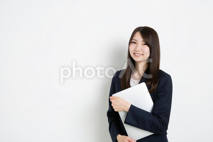 パソコンを抱えているビジネスウーマン（コピースペース） ビジネス,女性,スーツの写真素材
